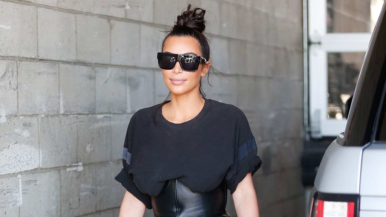 Kim Kardashian spills out of tight black corset as she steps off