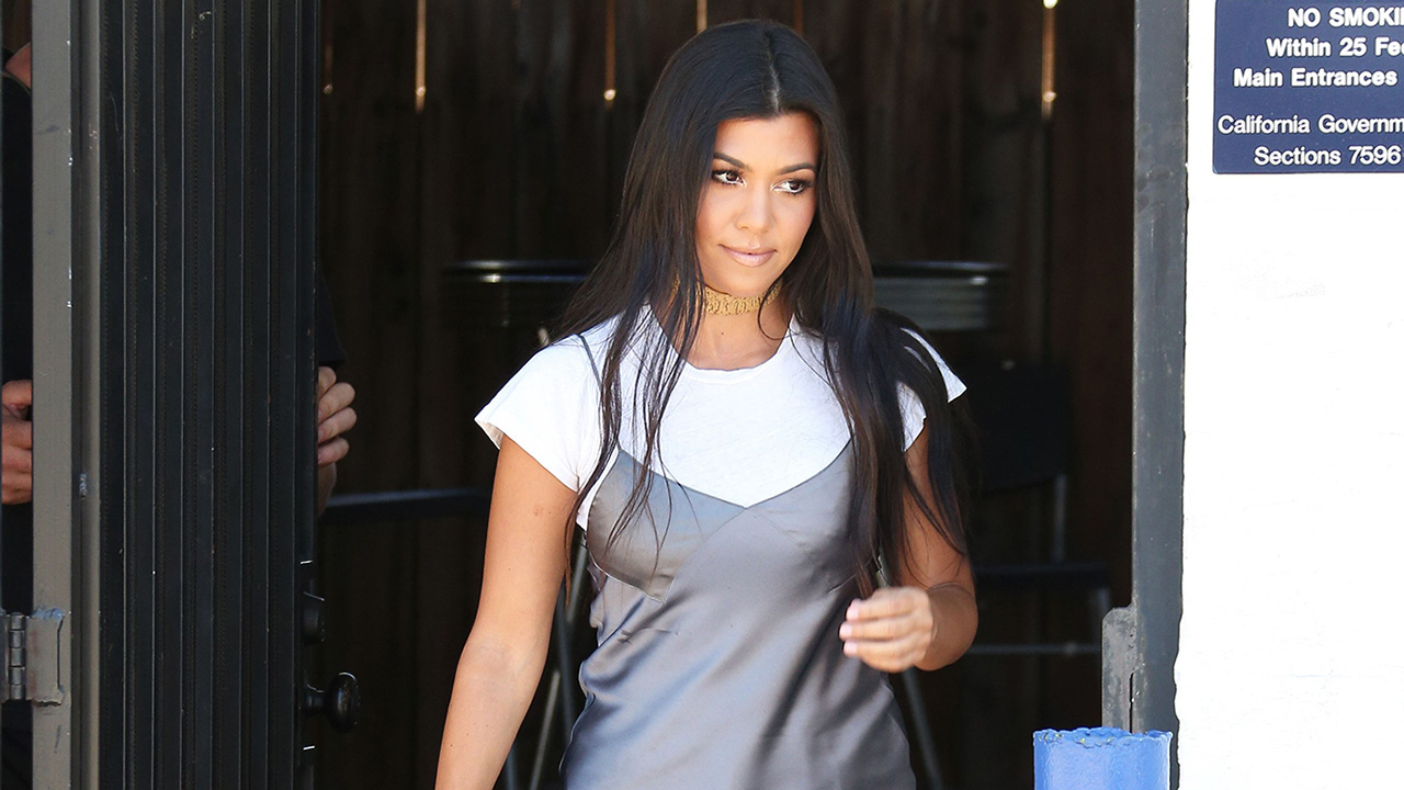 kourtney kardashian t shirt dress Kourtney Kardashian shows off tanned and toned legs beneath unique  over-sized shirt turned minidress